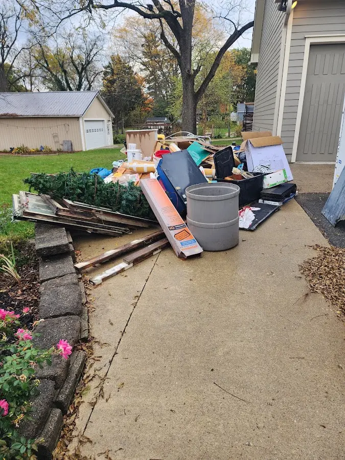 Dumpster being loaded with debris for 12 Yard Dumpster Rental in Bluffton